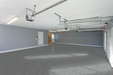 Rapids flake epoxy floor installed in a bright commercial garage or workspace with light blue tones.